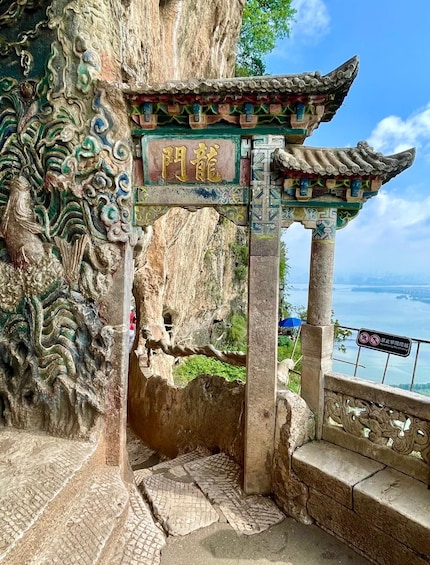 A traditional Chinese gate with intricate carvings and a sign reading 'Sun Gate.' 5