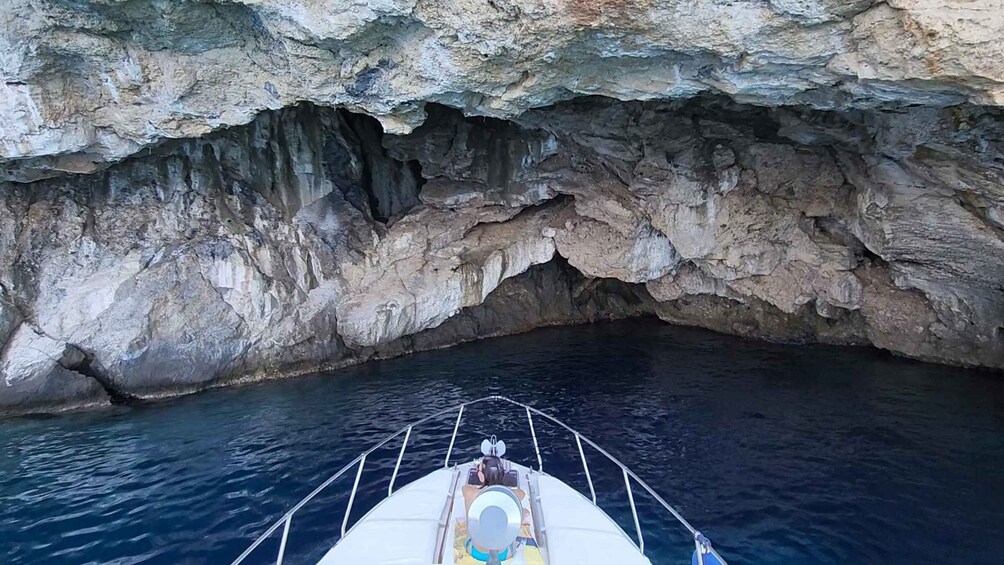 A boat navigating through a narrow waterway between rocky cliffs. 3