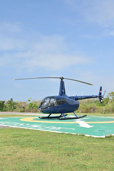 A blue helicopter with registration PK-VPY on a helipad. 3