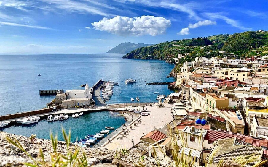 A coastal town with a marina, boats, and buildings along the waterfront. 2