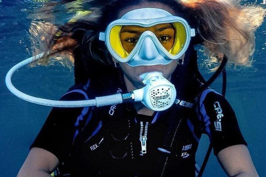 A person underwater wearing a scuba diving mask and snorkel. 1