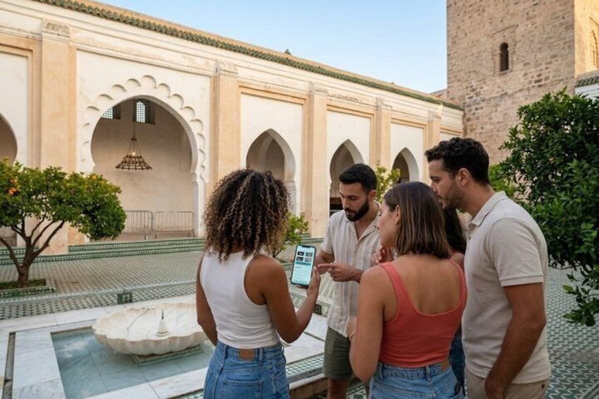 A group of people standing in a courtyard with arches and a fountain. 3