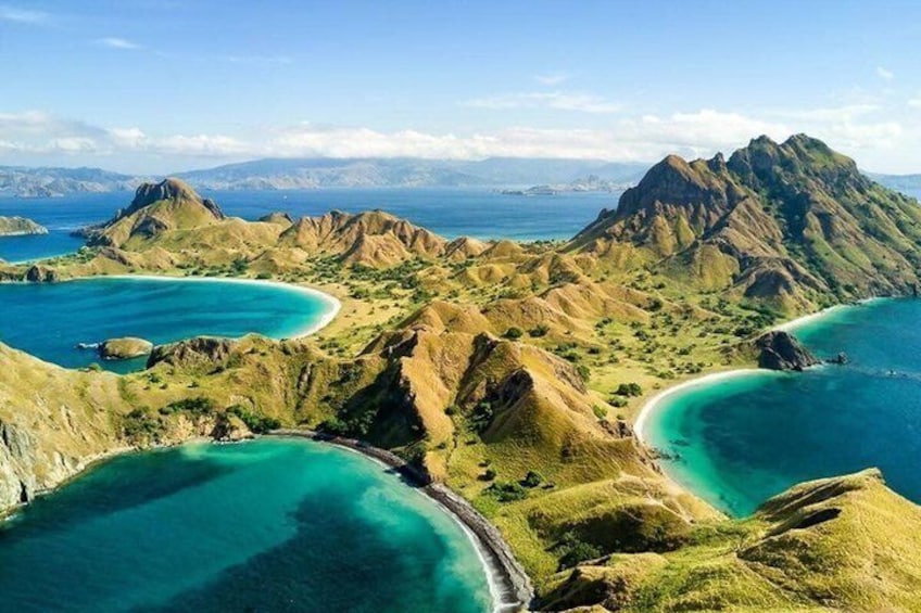 A mountainous landscape with turquoise waters and clear skies. 4