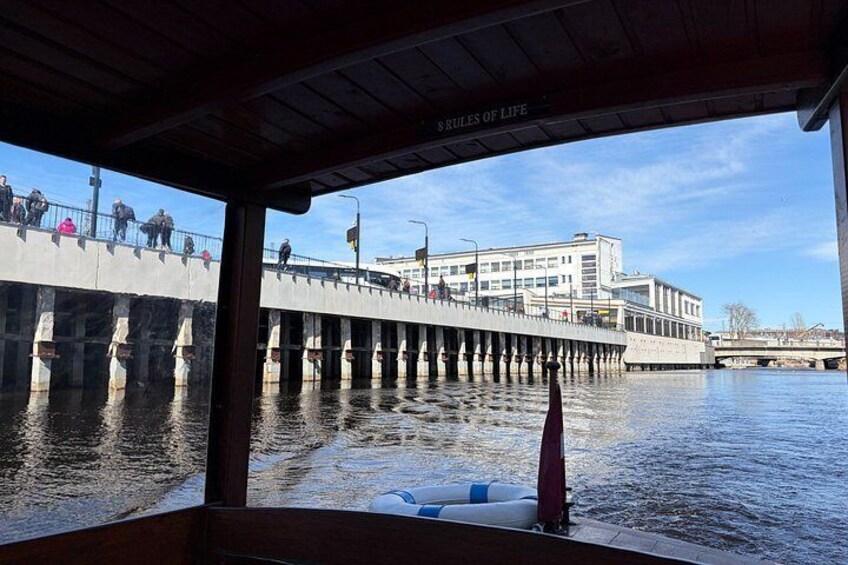 A pier extending into a body of water with a building in the background and a boat in the foreground. 2