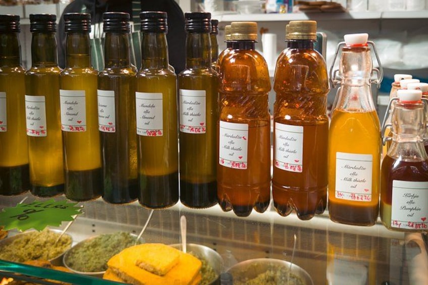 A variety of glass bottles with labels, likely containing different types of sauces or condiments. 5