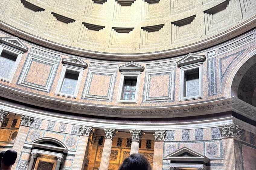 A grand interior with a domed ceiling, ornate columns, and detailed wall decorations. 4