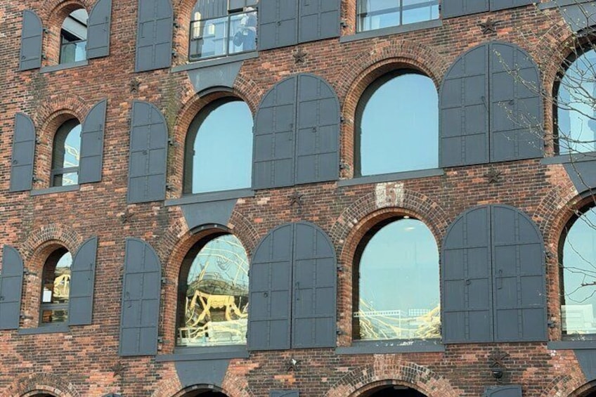 A brick building with multiple arched windows and a large circular skylight. 5