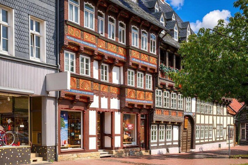 A traditional half-timbered building with a bicycle in the window. 3