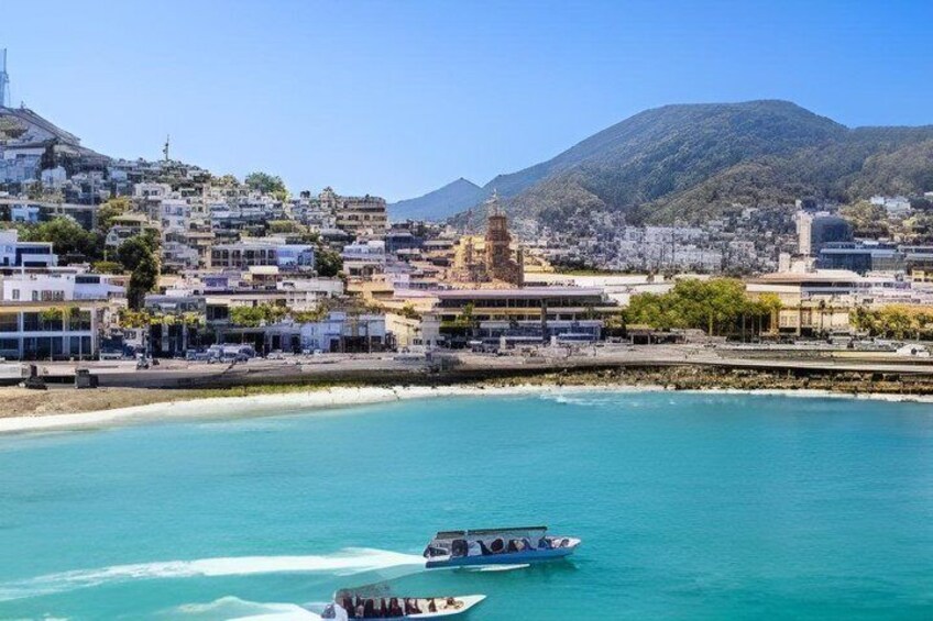 A coastal town with a prominent tower, boats on the water, and a mountainous backdrop. 2