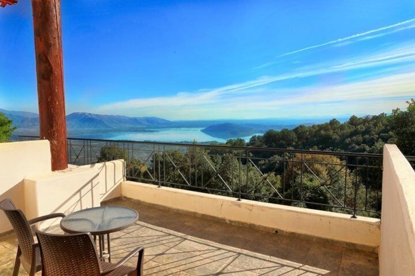 A balcony with a view of a lake and mountains. 2