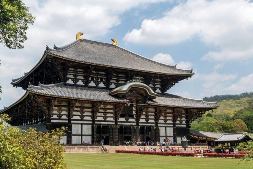 A traditional Japanese building with a curved roof and ornate wooden details. 3