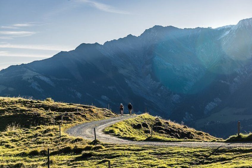 A mountain road with a cyclist and a hiker. 3