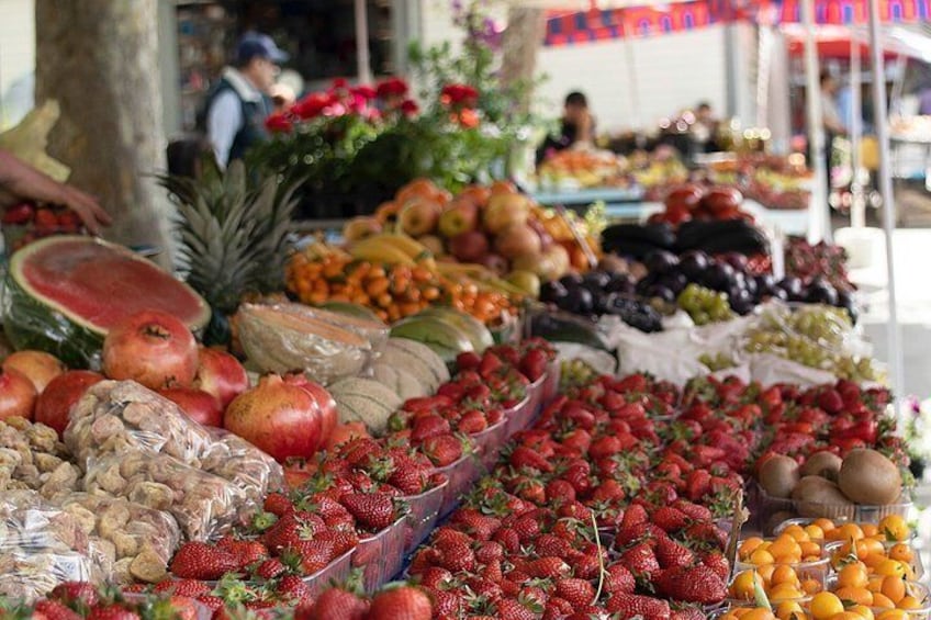 Un marché aux fruits où l’on peut trouver une variété de fruits, comme des fraises, des pommes et des oranges. 1