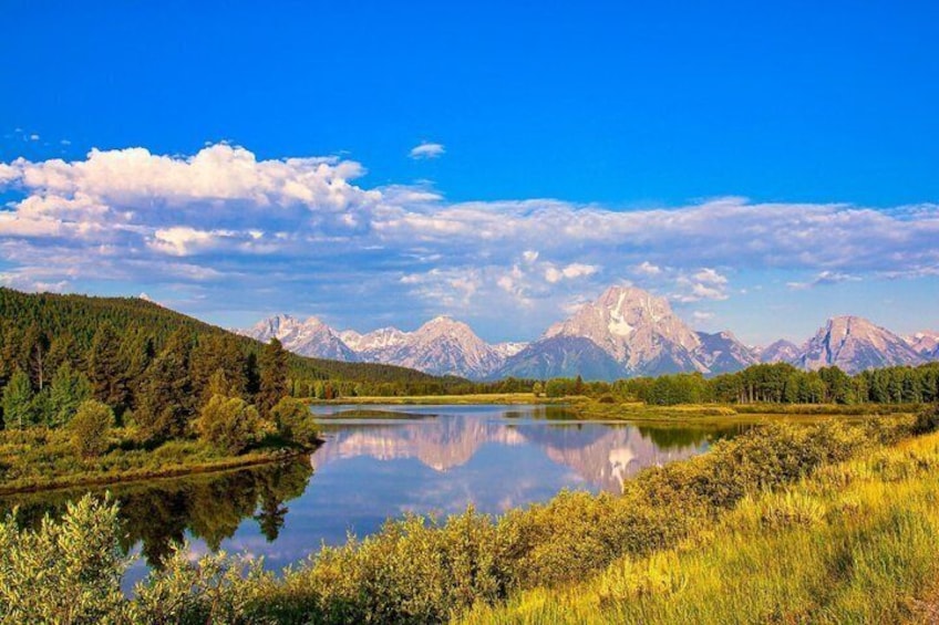 A lake surrounded by mountains and forest. 1
