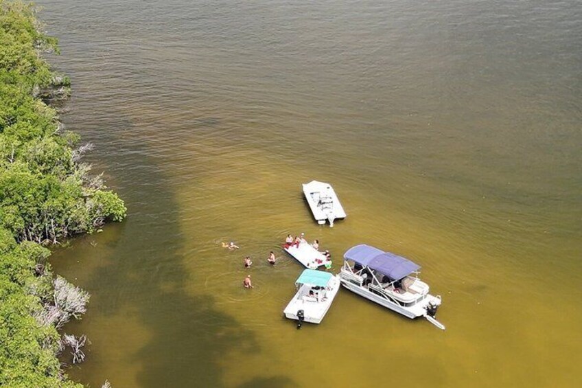 A lake with boats and people swimming. 5
