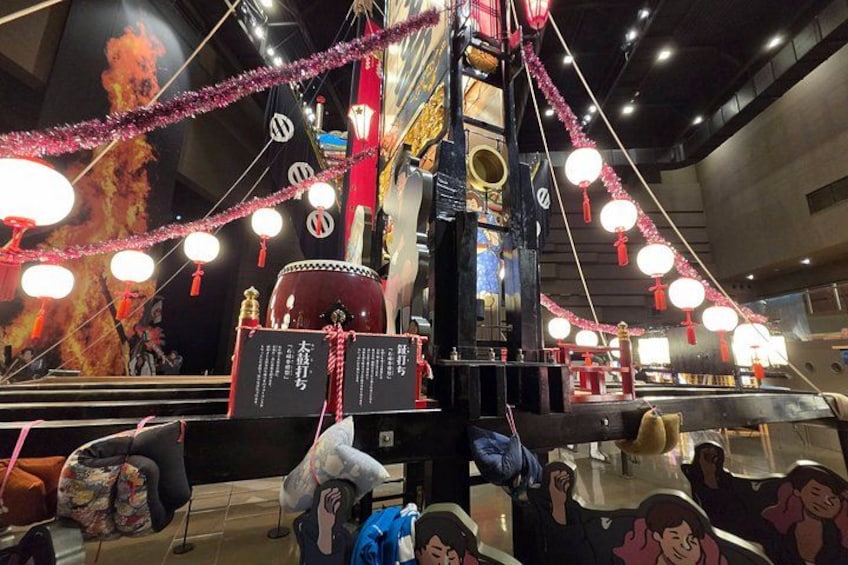A traditional Chinese temple with red lanterns, incense burners, and a large drum. 3
