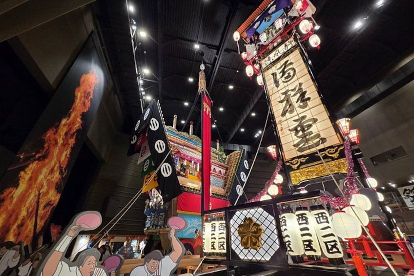 A traditional Chinese lantern with Chinese characters, a red and gold decorative structure, and a large flame. 1