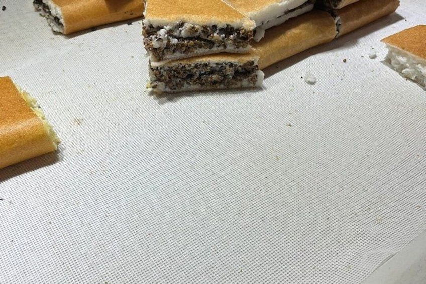 A stack of layered desserts on a white surface. 3