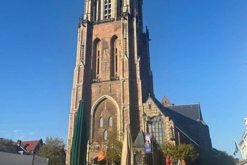 A tall brick church with a prominent tower and arched windows. 3