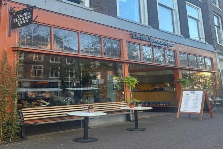 A restaurant named 'Delta Brown House' with outdoor seating and a menu board. 4