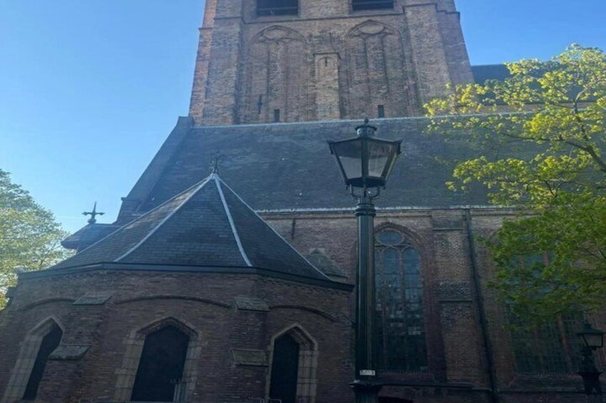A church with a prominent tower and a street lamp in front. 5