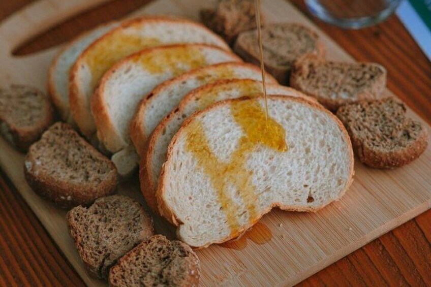 Slices of white bread with olive oil on a wooden cutting board. 4