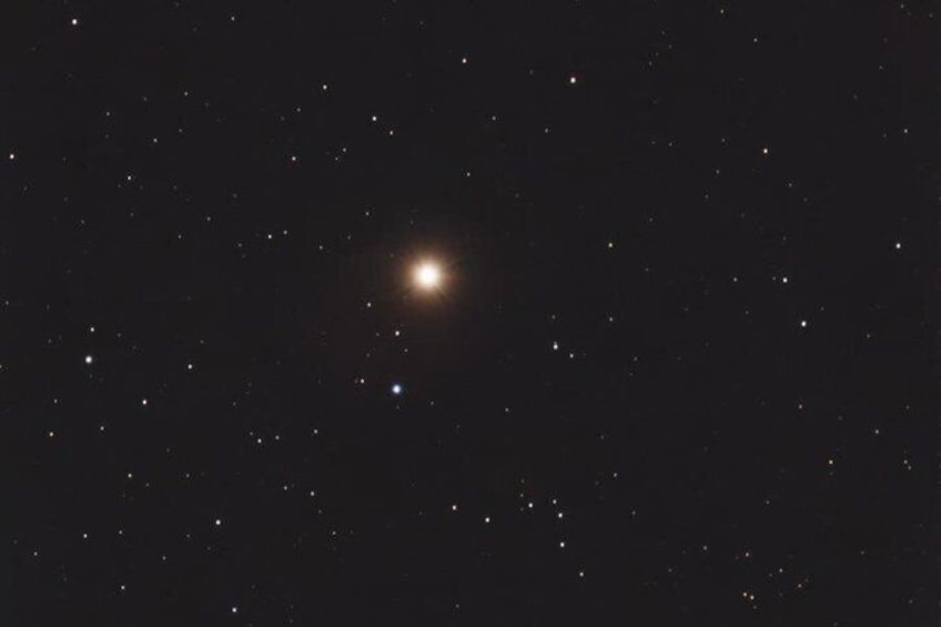 Un ciel nocturne étoilé avec un astre brillant au centre. 5