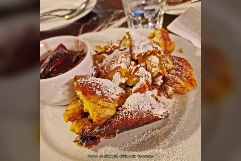 A plate of bread with powdered sugar and a small bowl of jam. 5