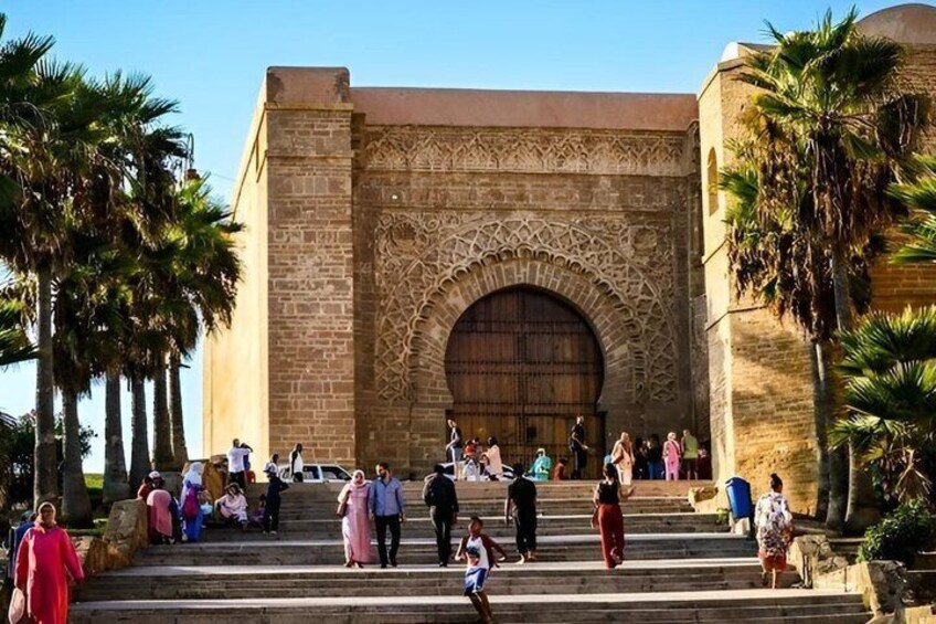 A historic building with intricate arches and steps leading up to it. 3