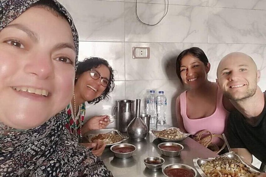 A group of people sitting at a table with food and drinks. 3