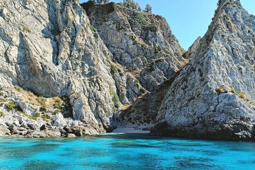 A rocky coastline with clear blue waters. 3