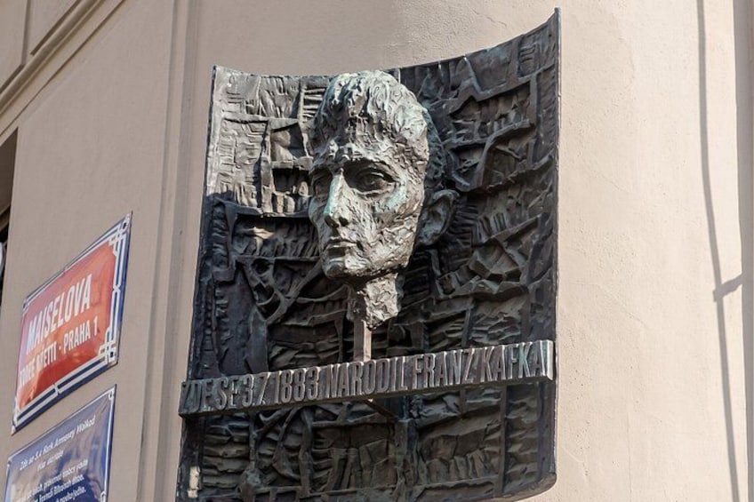 A bronze bust with inscriptions on a wall. 3