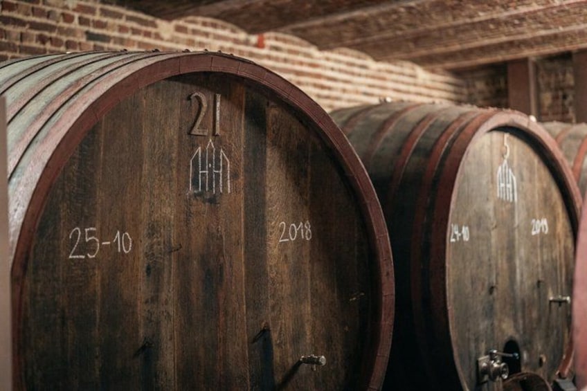 Wooden barrels with numbers and dates, likely used for aging wine or spirits. 3