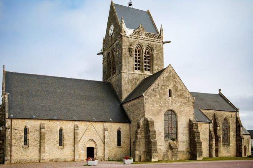 Een historisch kerkgebouw met een opvallende toren en gotische ramen. 5