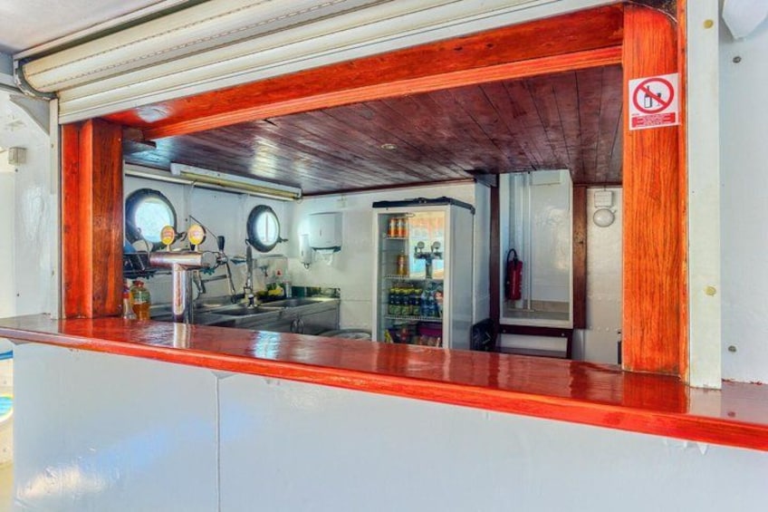 A kitchen with wooden accents, a no smoking sign, and a visible fire extinguisher. 3