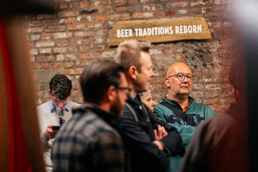 A brick wall with a sign that reads 'BEER TRADITIONS REBORN'. 4