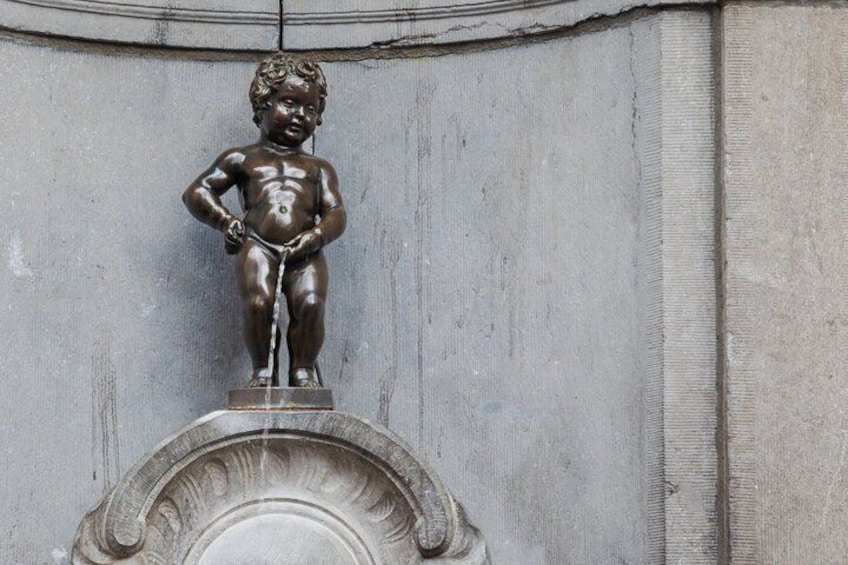 A bronze statue of a child on a pedestal. 3