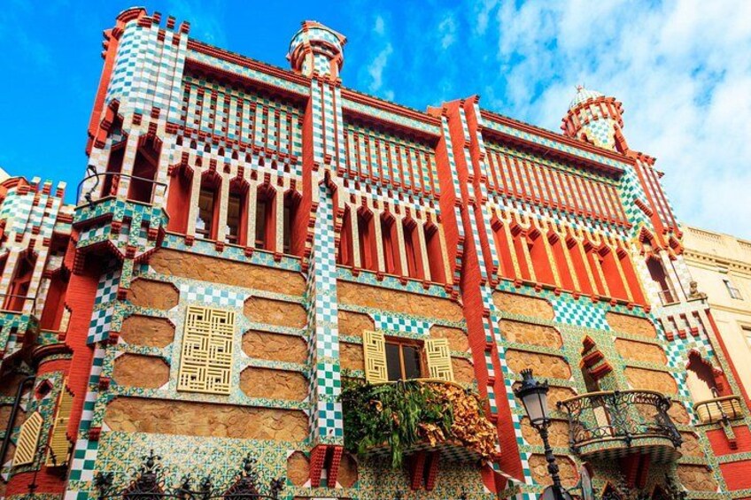 A building with ornate red and white checkered patterns, intricate window designs, and decorative balconies. 3