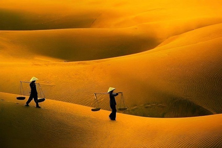 Two people walking on sand dunes with scales on their heads. 5
