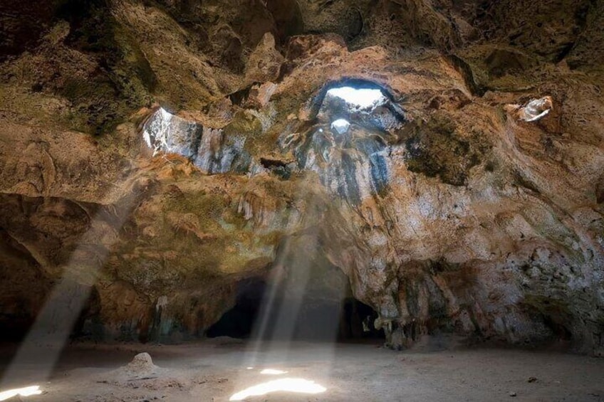 A cave with stalactites and a central opening. 5