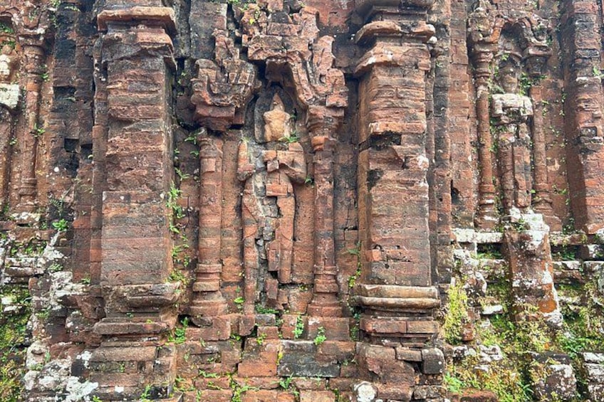 Ancient brick ruins with columns and intricate carvings. 3