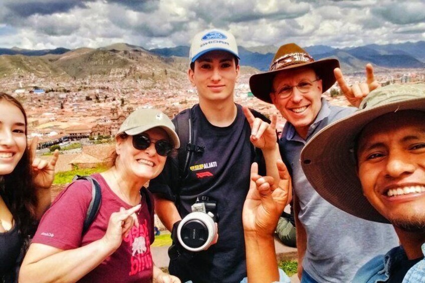 A group of people in a mountainous landscape with a city in the background. 4