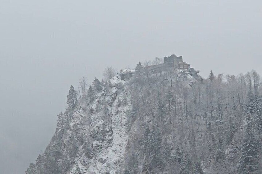 A snow-covered mountain with a castle-like structure on top. 2