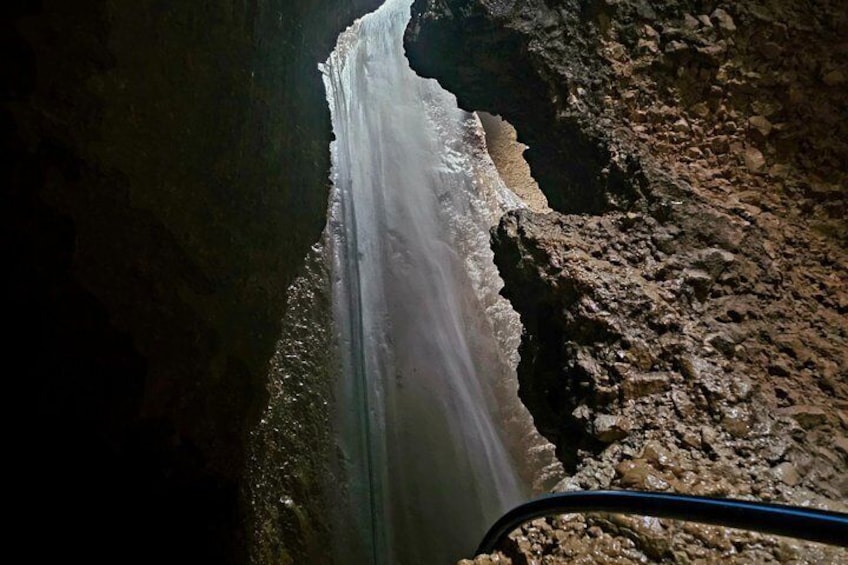 A narrow canyon with a visible water stream. 1