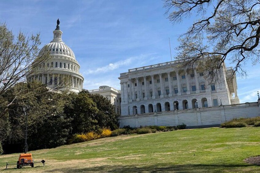 The United States Capitol building, a large white dome, and a smaller building with columns. 1