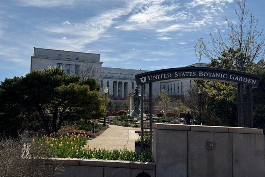 The United States Botanic Garden entrance with a large building in the background. 3