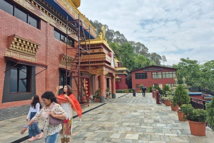 A building with red brick walls, a golden entrance, and a staircase. 1