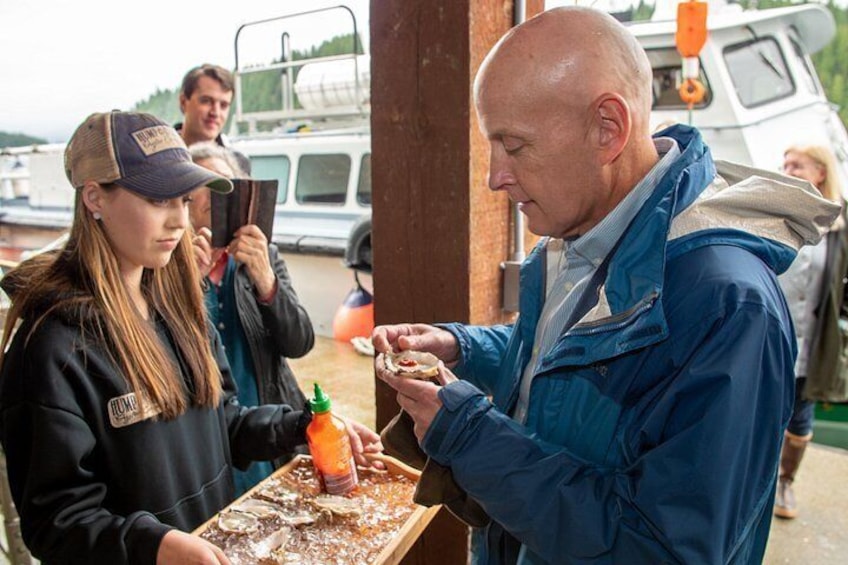 A person handing over a tray with food to another individual. 2