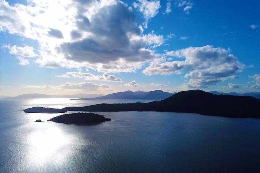 A calm sea with islands and a clear sky. 5