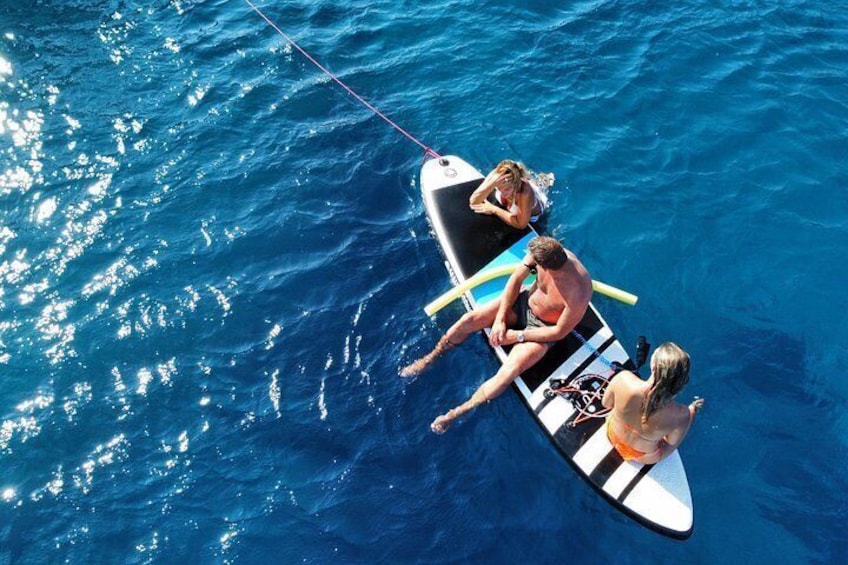 A person on a surfboard in the ocean. 5